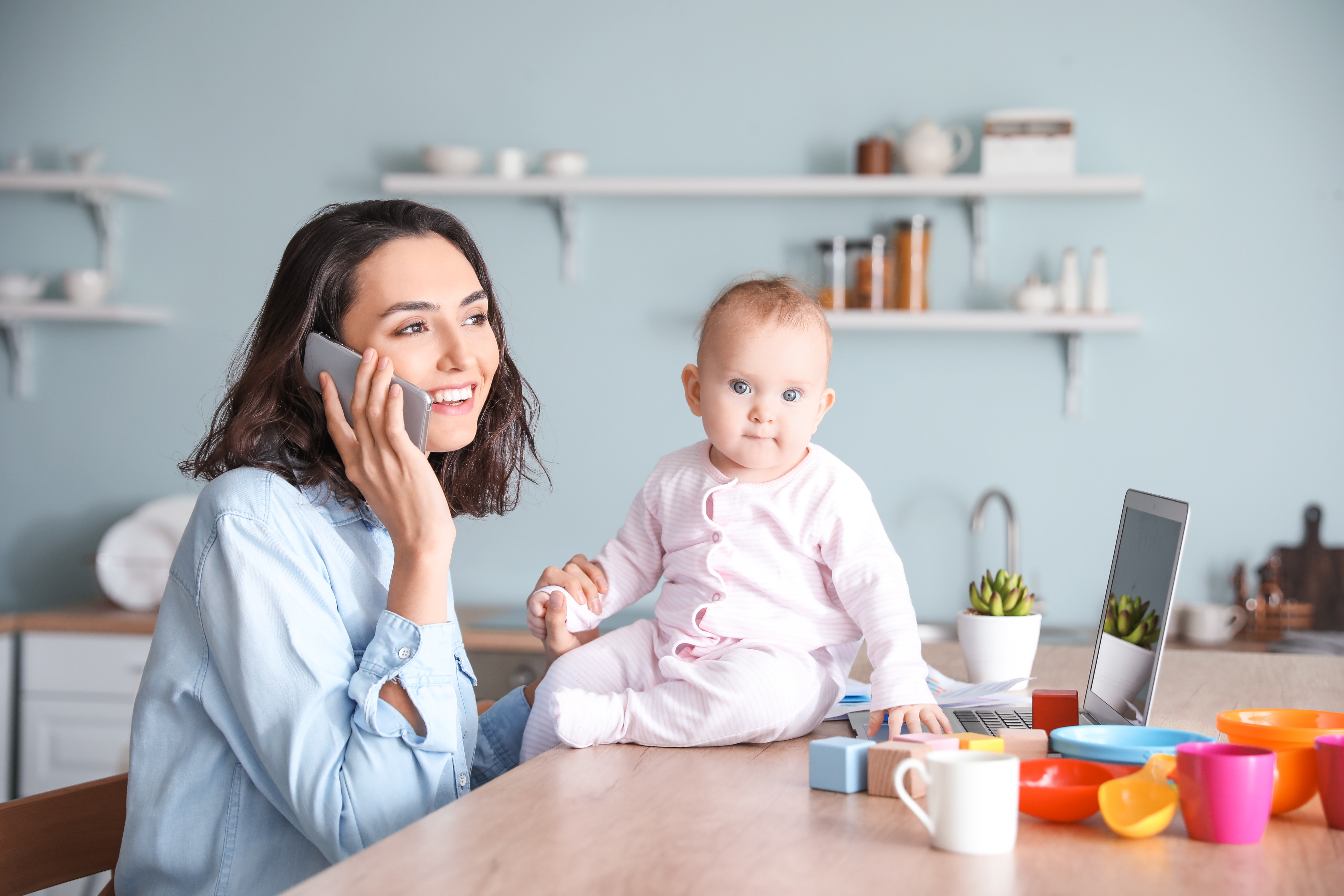 Working mother with her baby at home